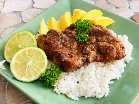 A plate of spaghetti garnished with basil and fresh vegetables, showcasing Italian cuisine.